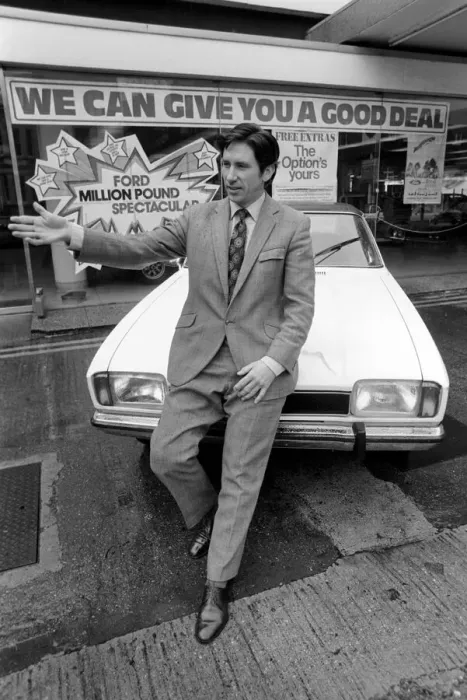 Framed Print : A car dealer putting cars on sale in his garage forecourt in Brighton. May 1975 Framed Print : A car dealer putting cars on sale in his garage forecourt in Brighton. May 1975