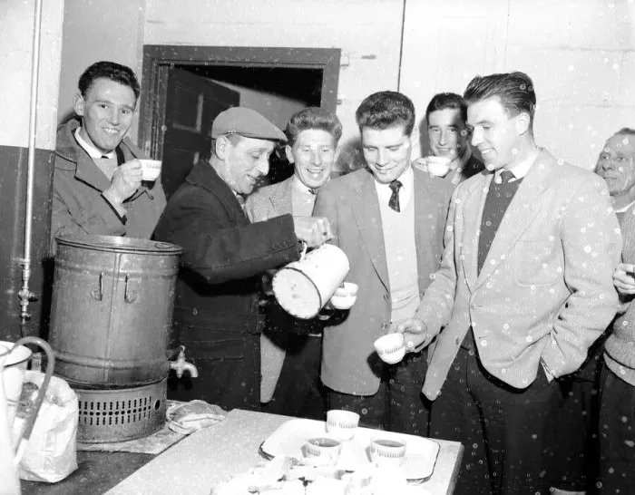 Framed Print : Cardiff City footballer Colin Baker is poured a cup of tea by the groundsman following a Framed Print : Cardiff City footballer Colin Baker is poured a cup of tea by the groundsman following a