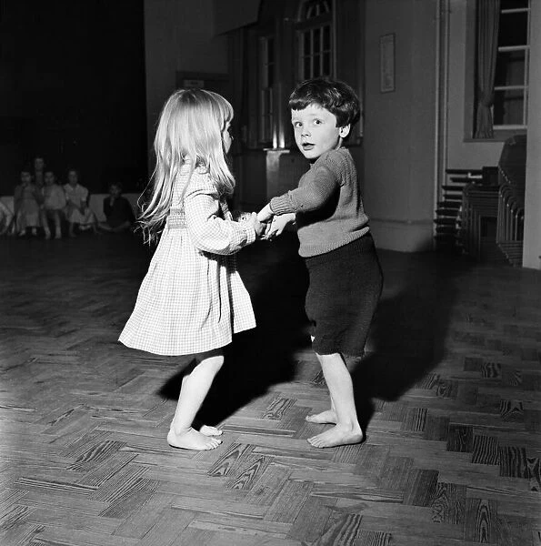 Would you care for the next dance? Infant schoolchildren playing during a dance