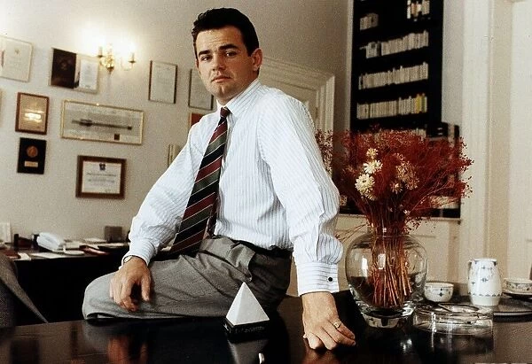 Will Carling rugby player sitting on desk
