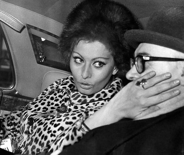 Carlo Ponti film producer has his cheek stroked by Sophia Loren actress