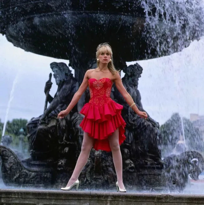Framed Print : Carol Smillie model TV presenter wearing red dress standing ion front of a water fountain