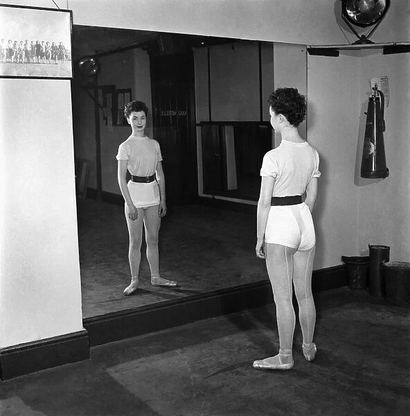 Carole Logan windmill girl doing stretches at the gym. November 1952 C5670-002