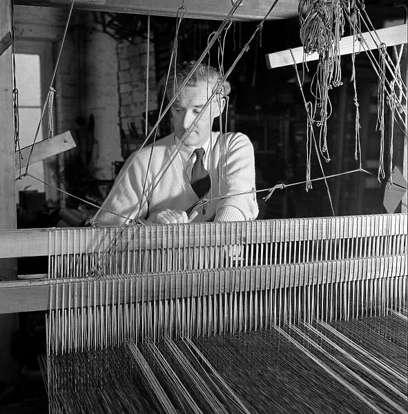 Carpet Making Picture shows a man working on his loom