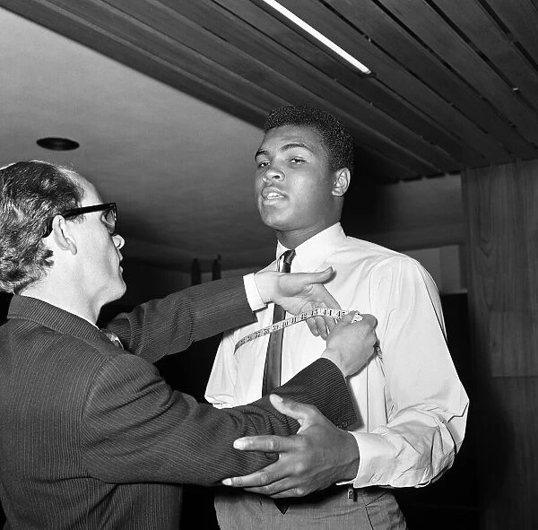 Cassius Clay aka (Muhammad Ali) getting measured at Austin Reeds in London