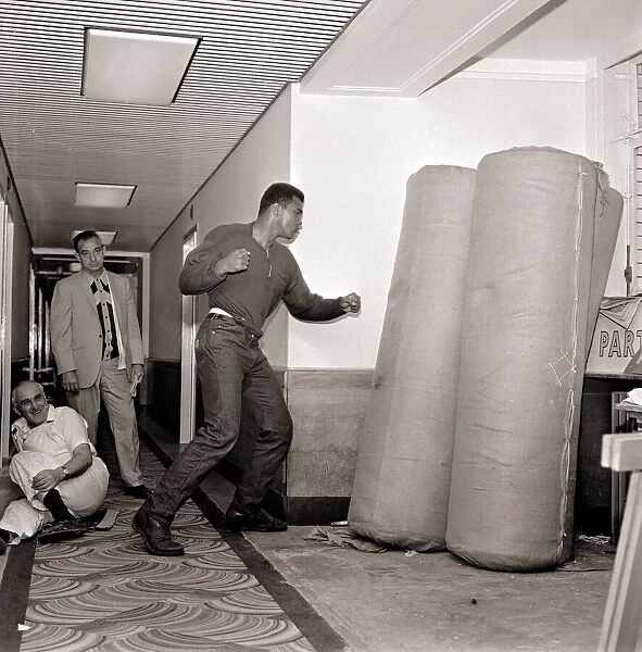 Cassius Clay August 1966 In training punching bags. Boxing 1960s