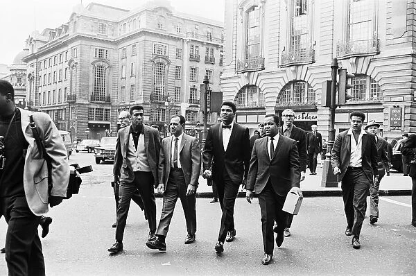 Cassius Clay (centre) and entourage in Piccadilly Circus on route to his press conference