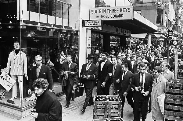 Cassius Clay (centre) and entourage on route to his press conference for his upcoming