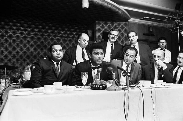 Cassius Clay (centre) holding a press conference prior to his rematch with Henry Cooper
