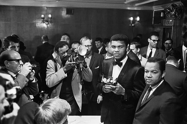 Cassius Clay holds a case with 24 carrot gold coins in memory of Sir Winston Churchill