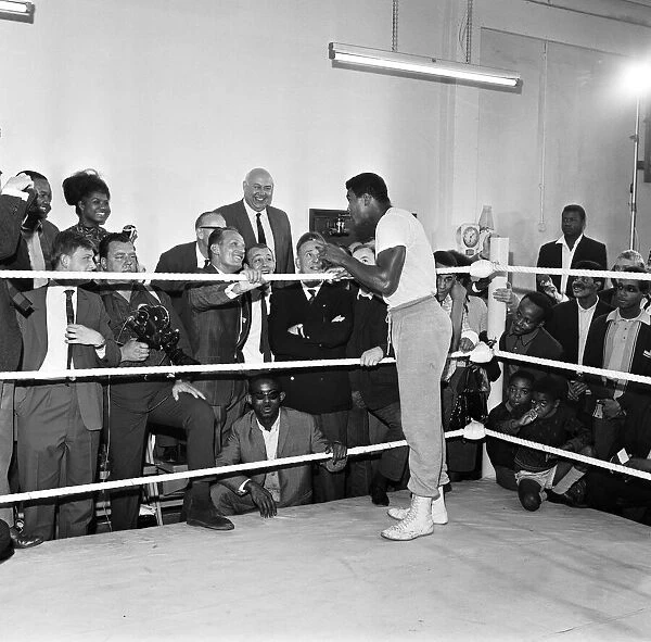 Cassius Clay later to become Muhammad Ali takes time out from training to share a few
