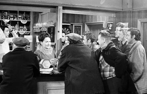 The cast of Coronation Street on set. Eileen Derbyshire behind the bar at