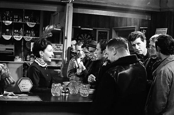 The cast of Coronation Street on set. Eileen Derbyshire behind the bar in