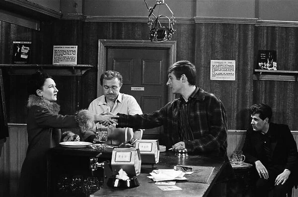 The cast of Coronation Street on set. Eileen Derbyshire behind the bar of