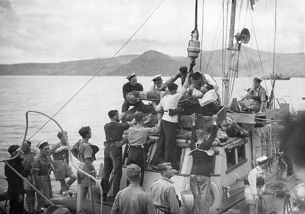 A casualty from a minesweeper being lifted on board the British cruiser Orion from a