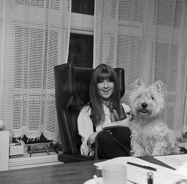Cathy McGowan, English Television Personality, pictured in her office with her dog