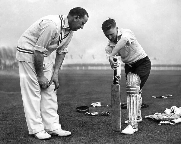 Cecil Pepper gives 22 year old John David Bond of Radcliffe cricket club a few tips