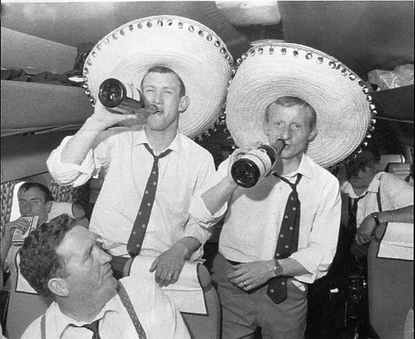 Two Celtic Players (IDs to follow) enjoy their champagne on the plane home