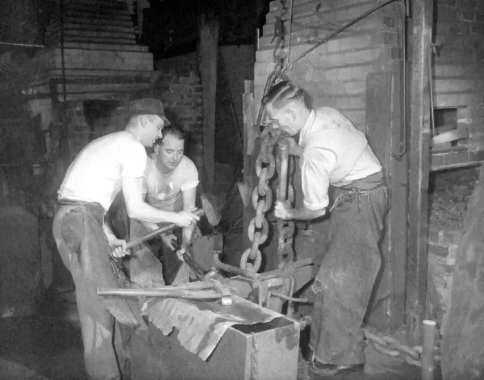 Framed Print : Chain-making is a hot, slogging job, but three who are used to the work are Framed Print : Chain-making is a hot, slogging job, but three who are used to the work are