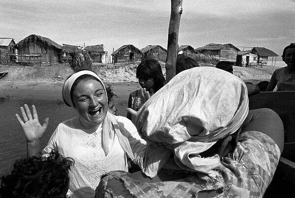 Charity worker laughing with one of the women from a poor area in Brazil