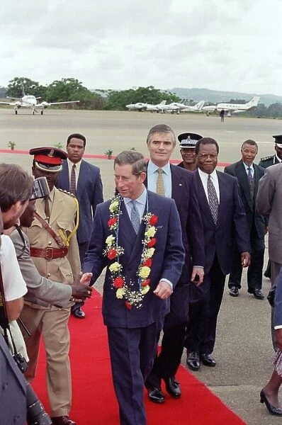 Charles, Prince of Wales, arrives in Swaziland, wearing a flower garland of carnations