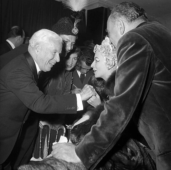 Charlie Chaplin talking with Madame Grund wife of French publisher at the Ice Ball in