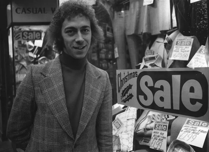 Framed Print : Charlie George football player of Arsenal December 1974 outside a men clothing