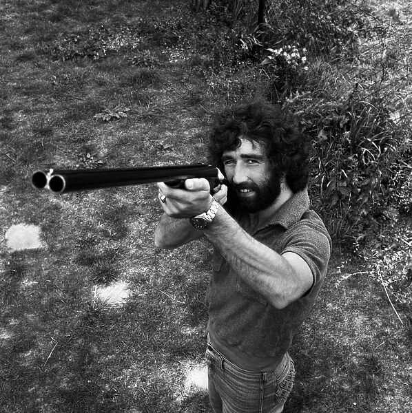 Charlton Athletic footballer Derek Hales poses with his shotgun while out duck shooting