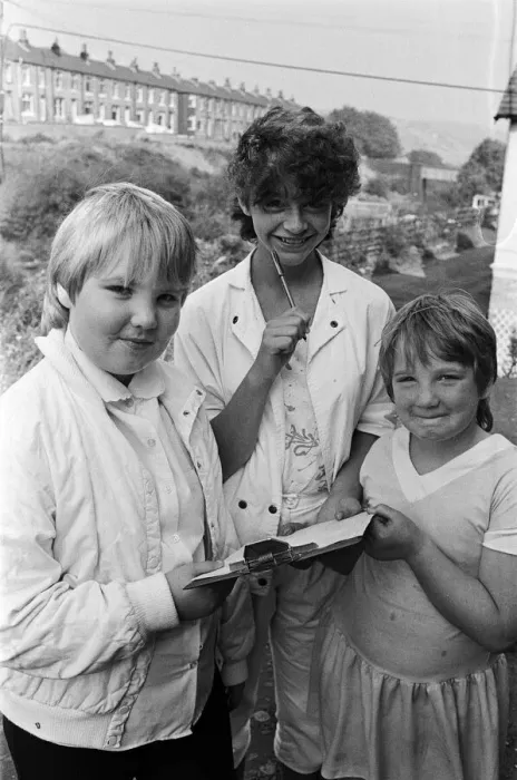 Framed Print : Checking the clues before setting out on a treasure hunt at Marsden are (from left