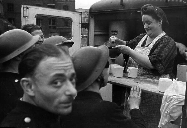 A cheery face behind a cup of tea - well earned refreshment for scores of soldiers