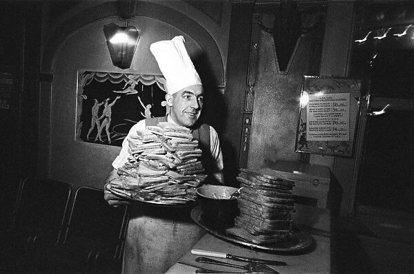 A chef with two huge piles of toast. April 1947
