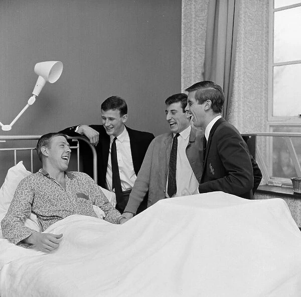 Chelsea and England right full back Ken Shellito is visited by Chelsea teammates Peter
