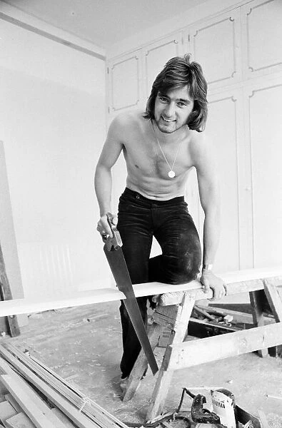 Chelsea footballer Alan Hudson tundertaking some DIY at his Putney home, May 1972