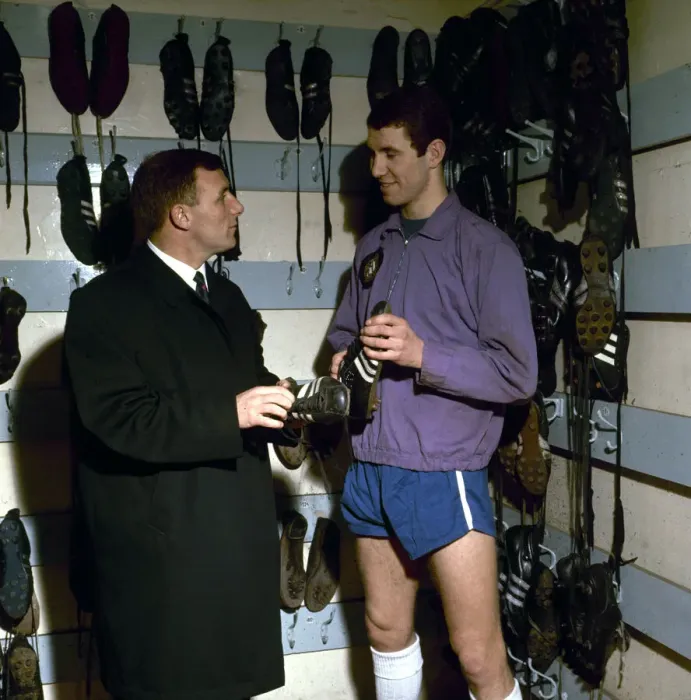 Framed Print : Chelsea footballer Peter Osgood in the boot room at Stamford Bridge with his manager Framed Print : Chelsea footballer Peter Osgood in the boot room at Stamford Bridge with his manager