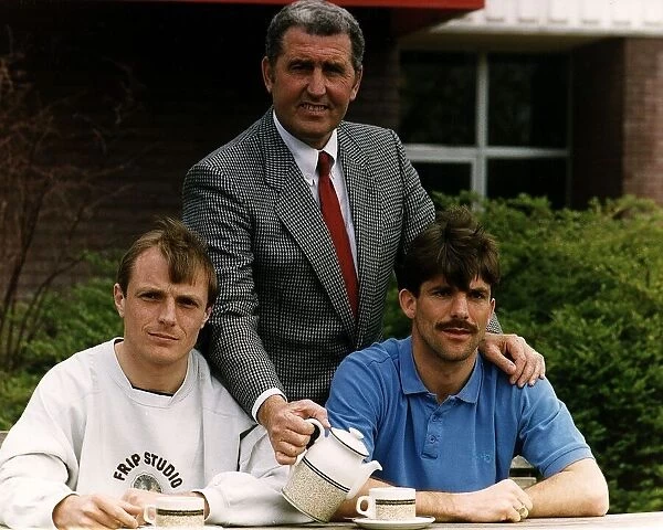 Chelsea manager Bobby Campbell pours a cup of tea for his two players John Bumstead (left