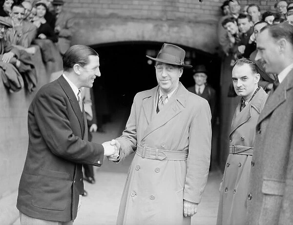 Chelsea Manager Ted Drake (left) shakes hands with the 1, 000