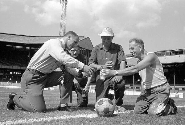 Chelsea manager Tommy Docherty christens the centre spot of the Stamford Bridge pitch