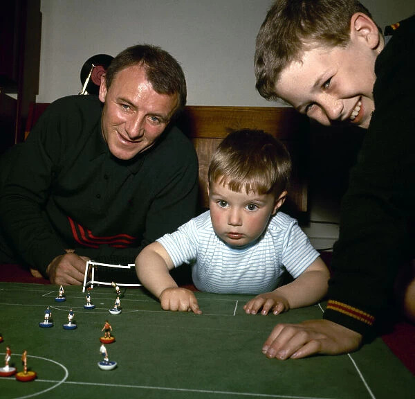 Chelsea manager Tommy Docherty playing Subbuteo at home with his children May 1967