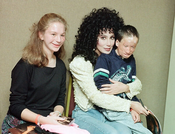Cher, American singer, presents cheque for 15, 000 pounds to representatives of