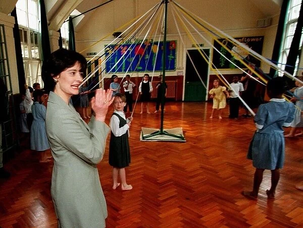 Cherie Blair wife of Tony Blair watches maypole dancing during a visit to Sudbourne