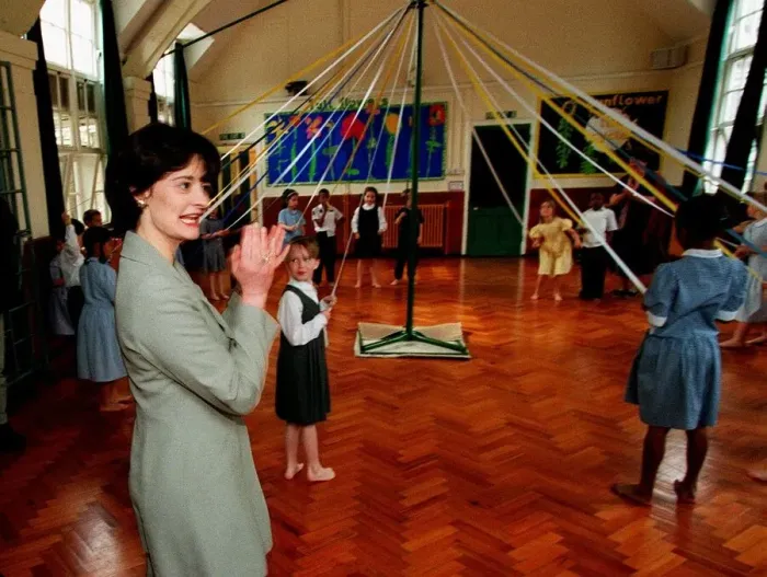 Framed Print : Cherie Blair wife of Tony Blair watches maypole dancing during a visit to Sudbourne