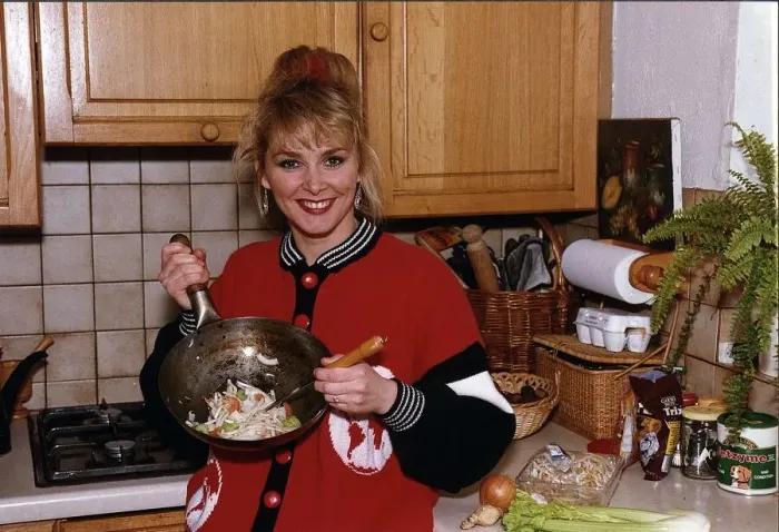 Framed Print : Cheryl Baker former Bucks Fizz singer and TV presenter cooking a stir fry in her kitchen Framed Print : Cheryl Baker former Bucks Fizz singer and TV presenter cooking a stir fry in her kitchen