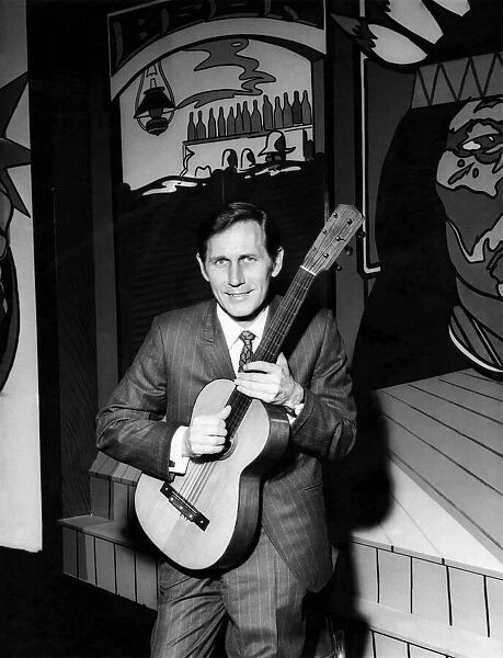Chet Atkins with a guitar he brought with him to present to the Nashville room