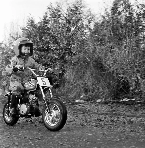 Child  /  Boy  /  Motorbike: Garry Jess, 3, ride minibike. January 1975 75-00555
