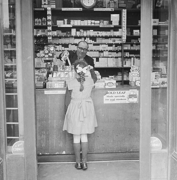 Child buying sweets at shop counter 9th April 1962