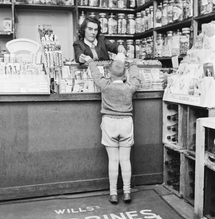 Framed Print : Child buying sweets at shop counter 9th April 1962 Framed Print : Child buying sweets at shop counter 9th April 1962