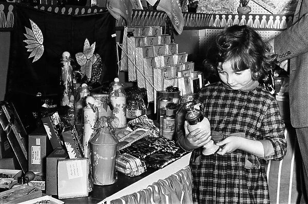 Child buys christmas present for mother, 27th November 1963