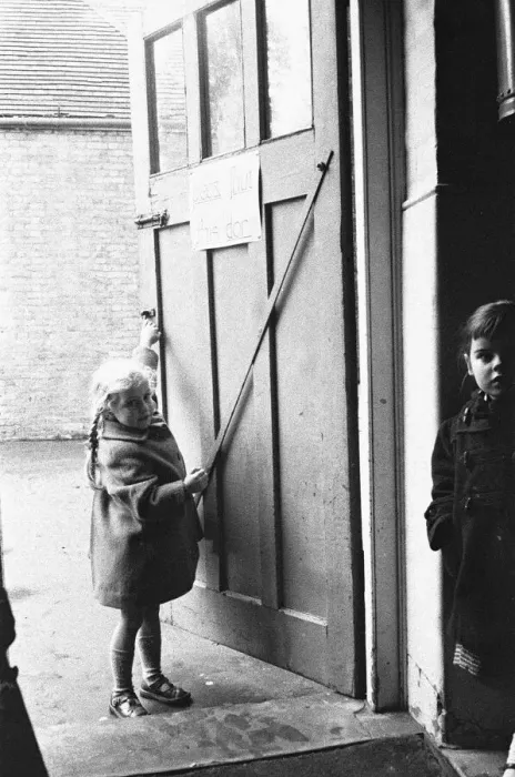 Framed Print : Child closing the door to the classroom following morning break at Roxeth Primary School