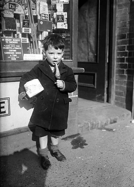 Child eating toffee. Circa 1940