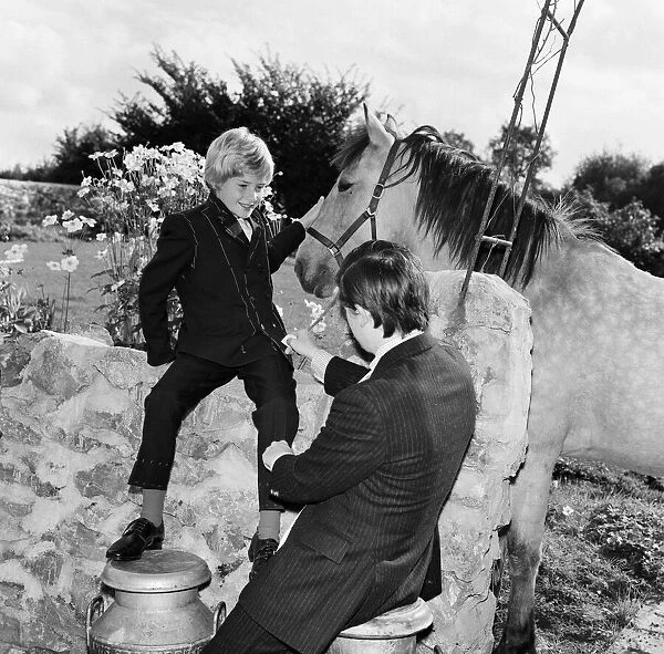 Child film star Mark Lester, 10 years old, being fitted for the suit which he will wear